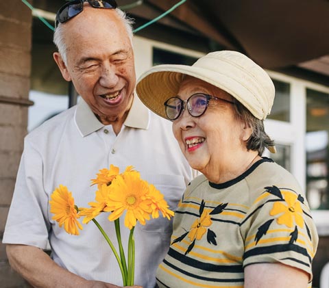 older couple holding flowers